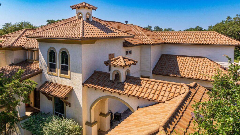 Image shows home which has a Decra metal roof in color "Amalfi Sand" which has the appearance of clay tiles