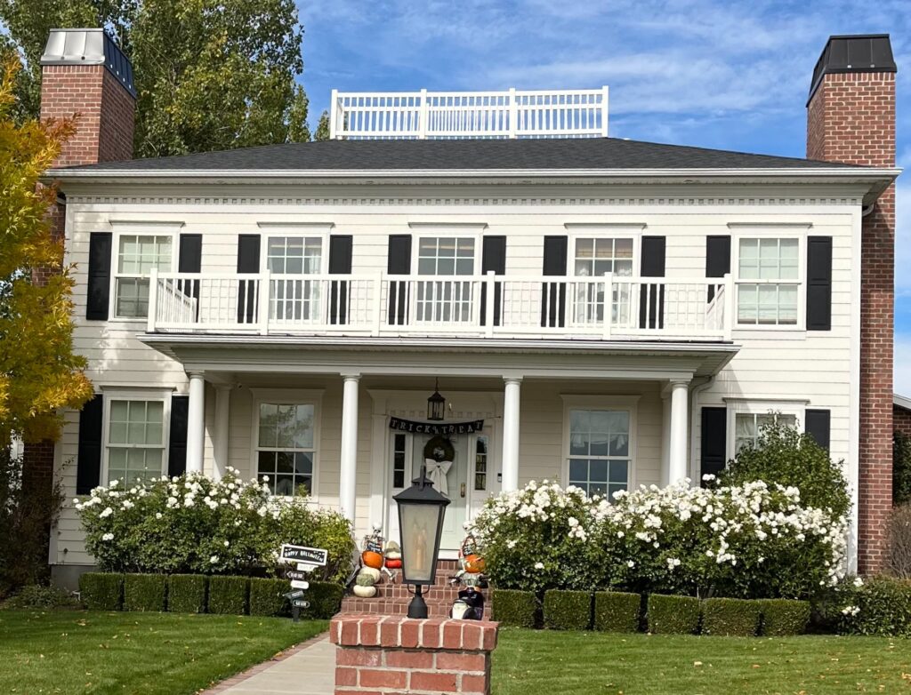 Image of Florida home with white clapboard siding and black shutters.